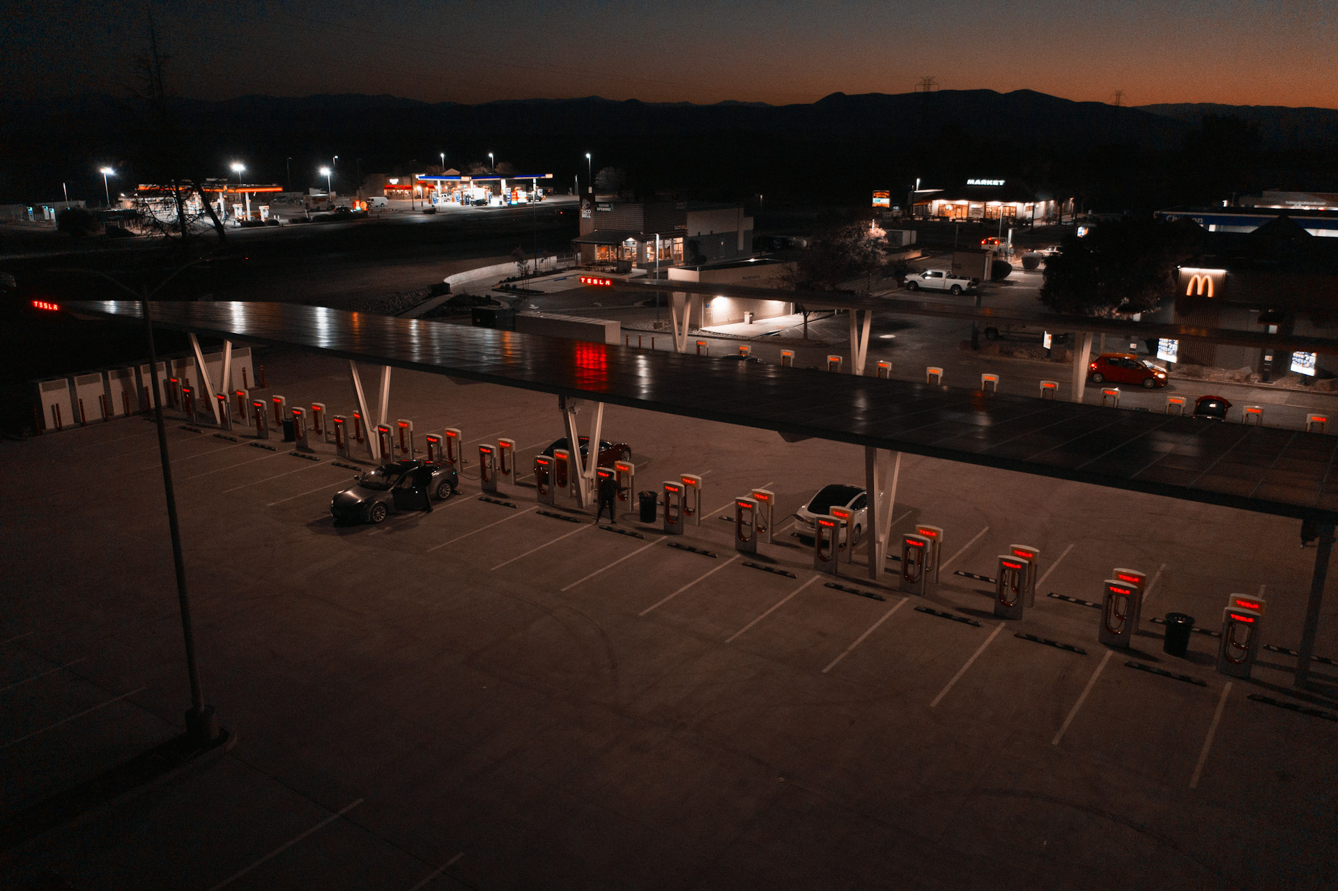 electric vehicle charging station lit up at night