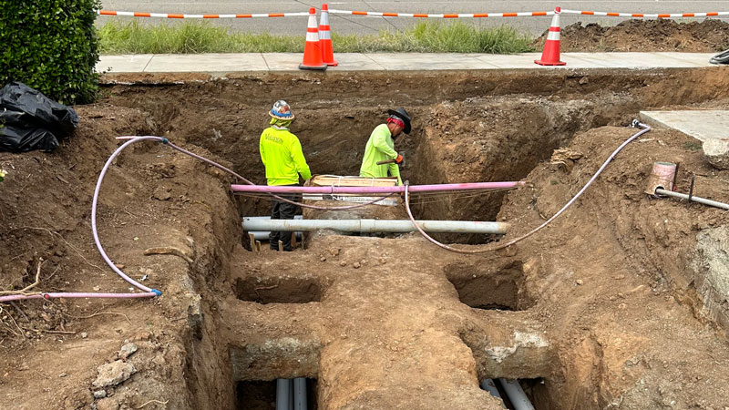 two construction workers working on a excavation and grading project